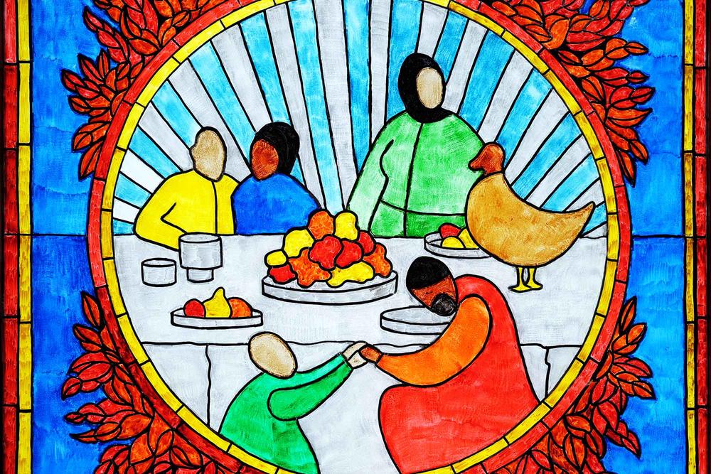 Colorful glass hand painting representing a diverse family around a table